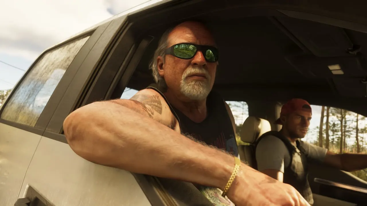 Brian Heder in green sunglasses, resting his arm on the window of a pickup truck