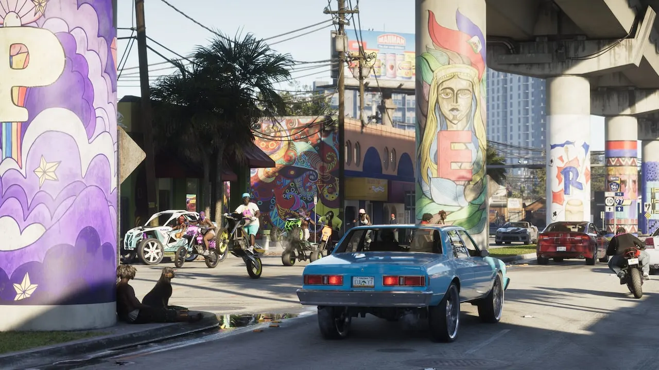 Classic cars and dirt bikes on a Vice City street under a mural-covered overpass