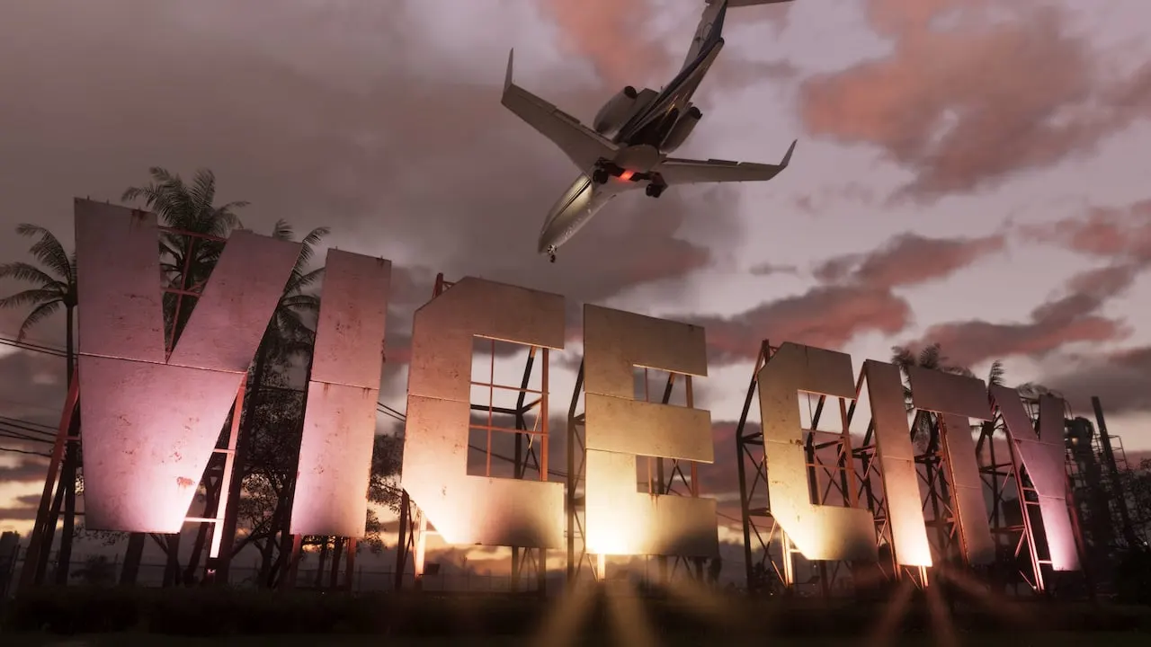 The giant Vice City sign lit up at dusk as a private jet flies low overhead